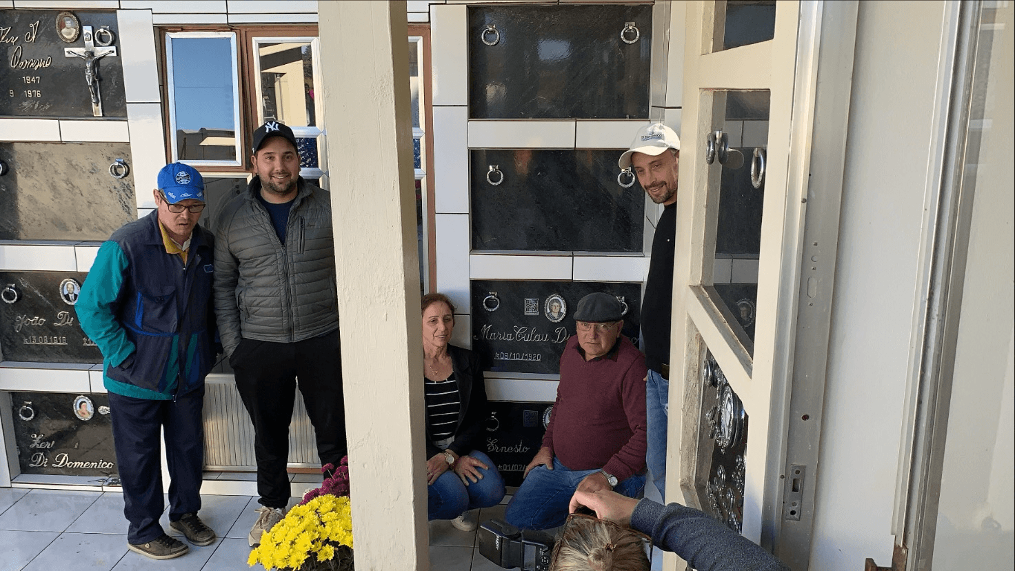Five relatives gathered beside a family memorial